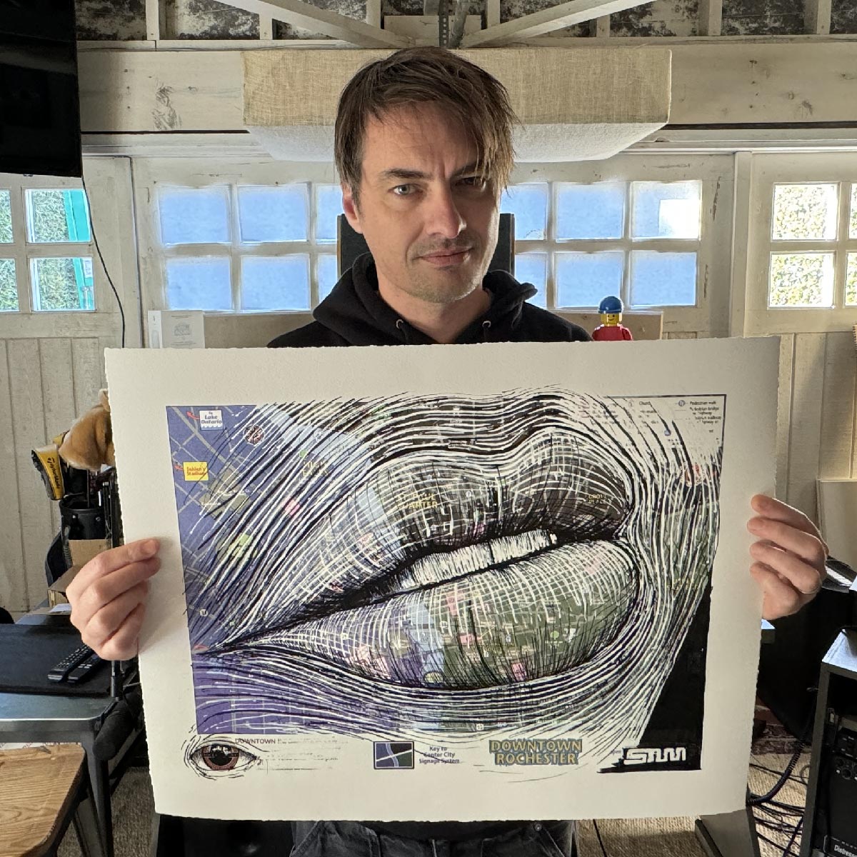 artist sam farrar holding his hand embellished edition ii of rochester