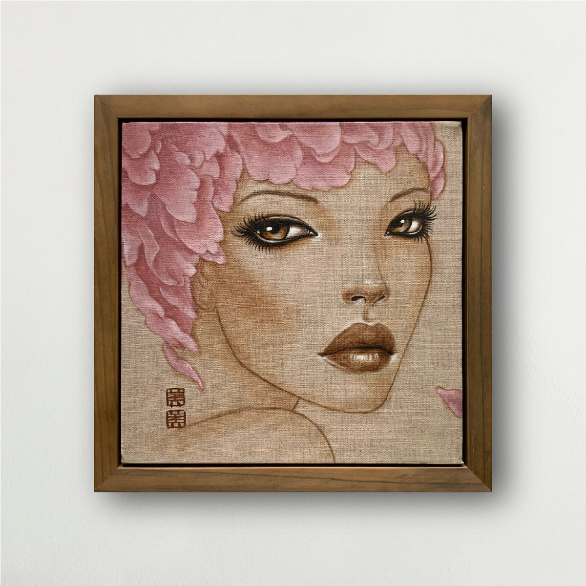 framed painting of a woman's face - she has large eyes and lips and is wearing a feather hat