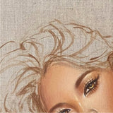 cropped image from a painting of a woman from the shoulders up, she has honey colored eyes and is leaning her head against her hands