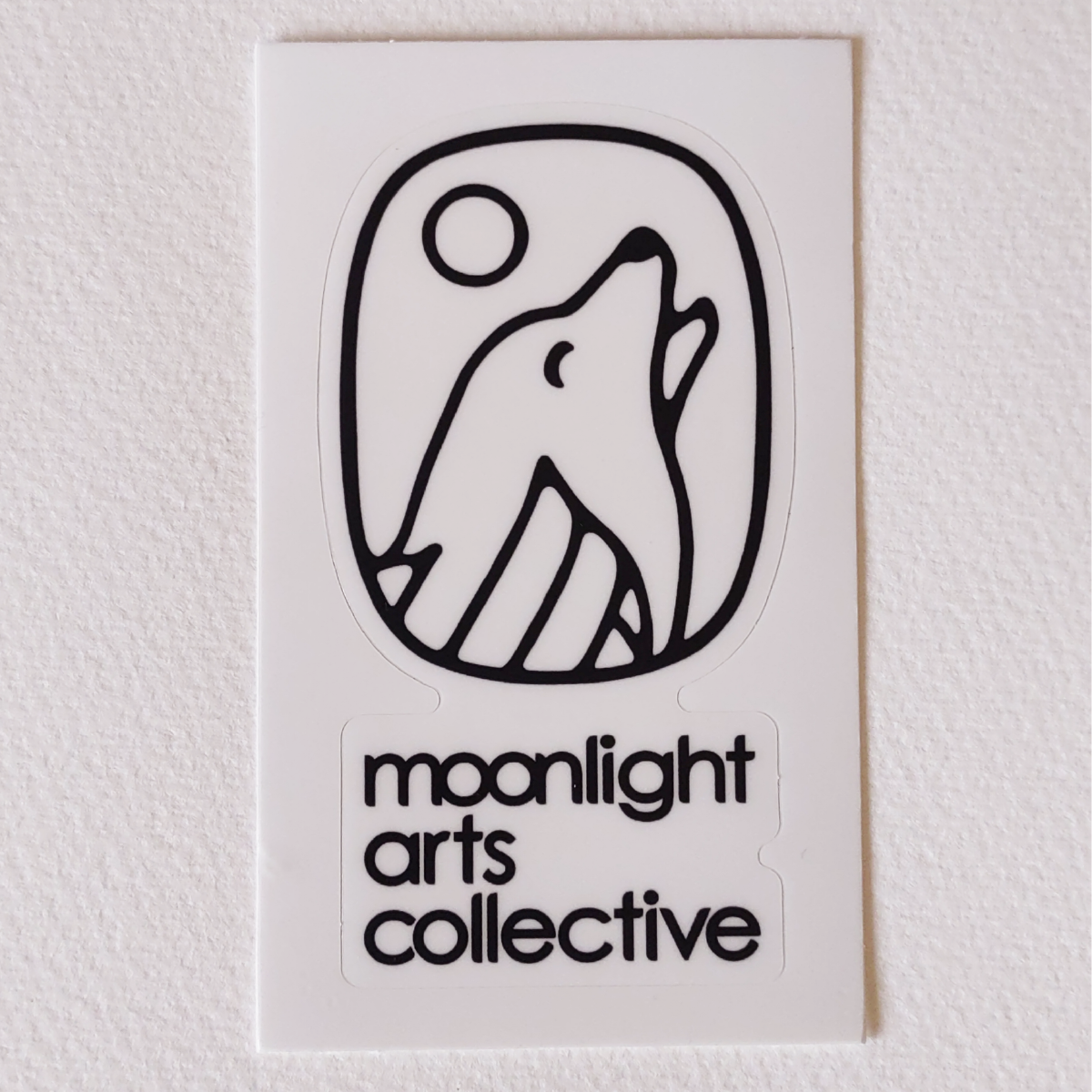moonlight arts collective sticker - black logo on white background
