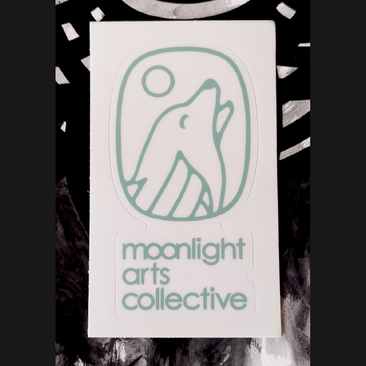 moonlight arts collective sticker - blue logo on white background