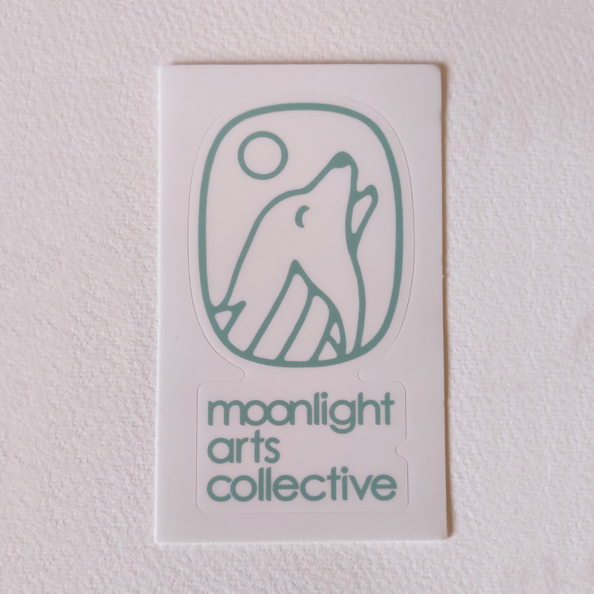 moonlight arts collective sticker - blue logo on white background