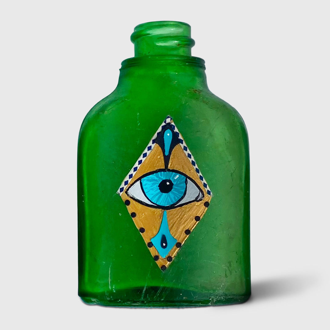 green bottle with eye